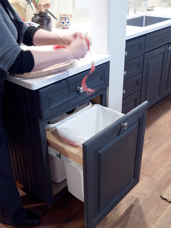 Plummer using one of her kitchen's built-in trash cans