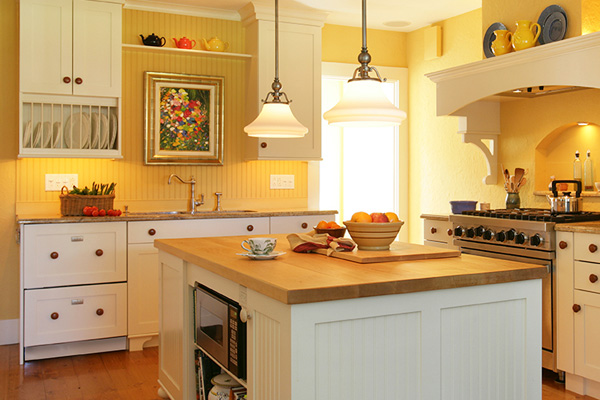 Kitchen staged with a bowl of fruit on the counter