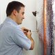Man maintaining a home water heater