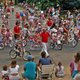 Kids riding bikes in a neighborhood Fourth of July parade