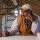 Contractor talking on telephone with client
