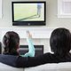 Couple watching TV in family room