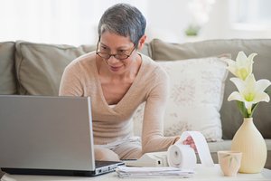 Woman in front of laptop in home