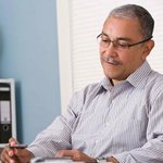 man-sitting-desk-home-office-getty Man sitting at desk in home office