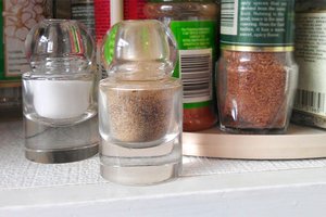 Salt and pepper shaker in a kitchen cabinet