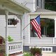Houses displaying the American flag on their porches