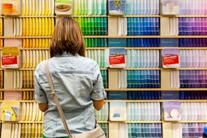 Woman standing in front of a wall of paint colors