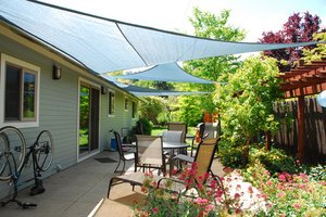 Shade sails over a back yard patio