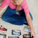 photo-sorting-home-inventory-loss-veer Woman sorting photos to find images of damaged house