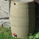 Plastic rain barrel installed at house