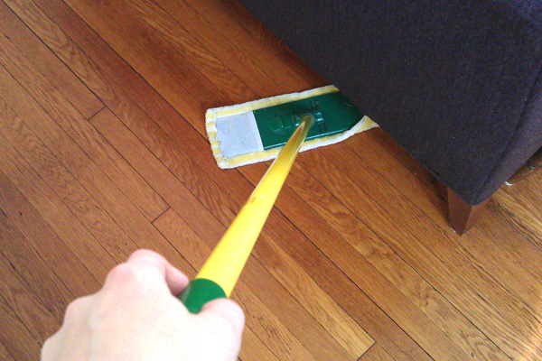 Dusting underneath a couch