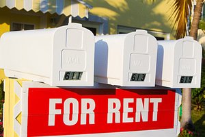 For rent sign in front of mailboxes