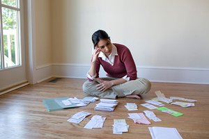 Woman in her living room working on her taxes