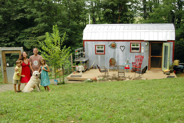 The Berzins family outside their tiny home