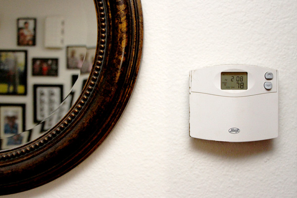 A thermostat on the wall of a home