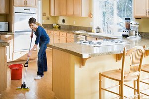 Woman cleaning kitchen with green products