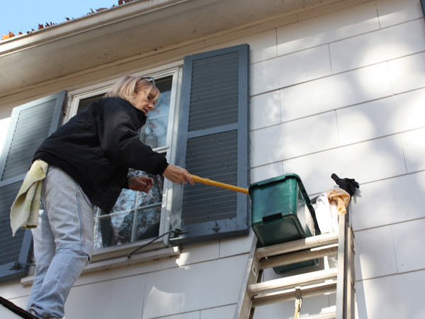 Washing the windows outside a house